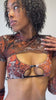 Video of a Model in a cropped top with cutout details and matching sleeves from Freedom Rave Wear, featuring a marbled brown pattern.