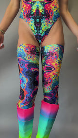 Video of Freedom Rave Wear's thigh-high leggings in a vibrant psychedelic pattern, paired with rainbow gradient platform boots.