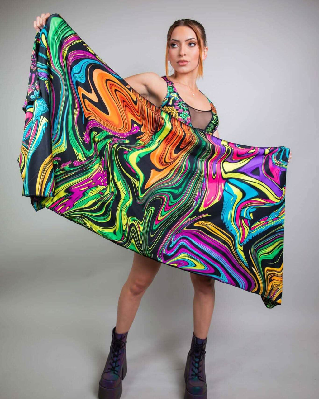 Model showcasing the vibrant PsyBloom Festival Scarf, featuring psychedelic swirls, perfect for rave outfits.