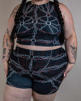 Model wearing the Purgatory Crop Top with chain design, perfect for rave outfits and festival fashion.