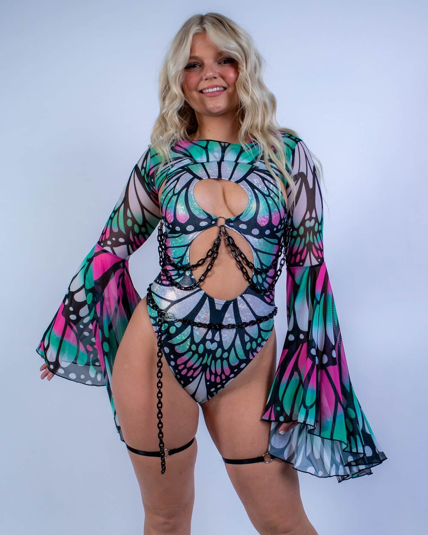 Rave arm sleeves with butterfly wing print in pink teal colors worn by blonde model festival outfit