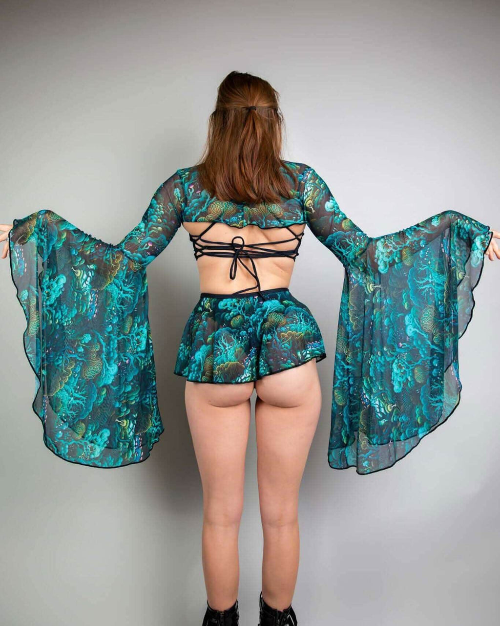 Faewood mesh rave arm sleeves back view showing dramatic bell sleeve flare in teal green festival outfit