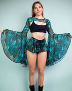 Faewood mesh rave arm sleeves in teal green with dramatic bell flare modeled front view festival outfit