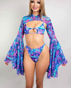 Blonde model wearing Fairycore rave arm sleeves with bell sleeves in blue purple pink festival outfit front view