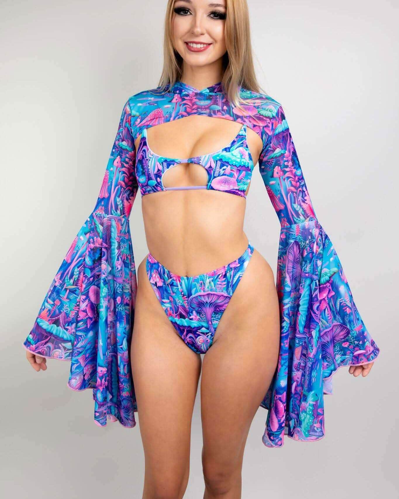 Blonde model wearing Fairycore rave arm sleeves with bell sleeves in blue purple pink festival outfit front view