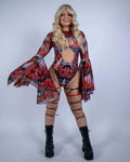 Blonde model showcasing Lacewing rave arm sleeves with dramatic bell sleeves in red and black mesh for festival outfit