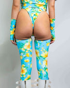 Rave arm sleeves and leg sleeves set in Lemon Drop tropical print shown from back view on model