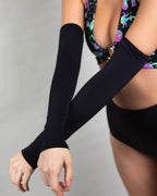 Matte black rave arm sleeves worn by festival model in colorful rave outfit front view