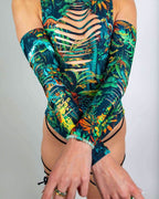 Mesozoic rave arm sleeves in tropical dinosaur print with chest cutouts, model front view pose