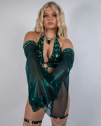Blonde model wearing emerald Predator Metamorphosis rave arm sleeves with sequined halter top front view