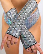 Prism rave arm sleeves with holographic geometric pattern modeled in crossed arms pose for festival outfit styling