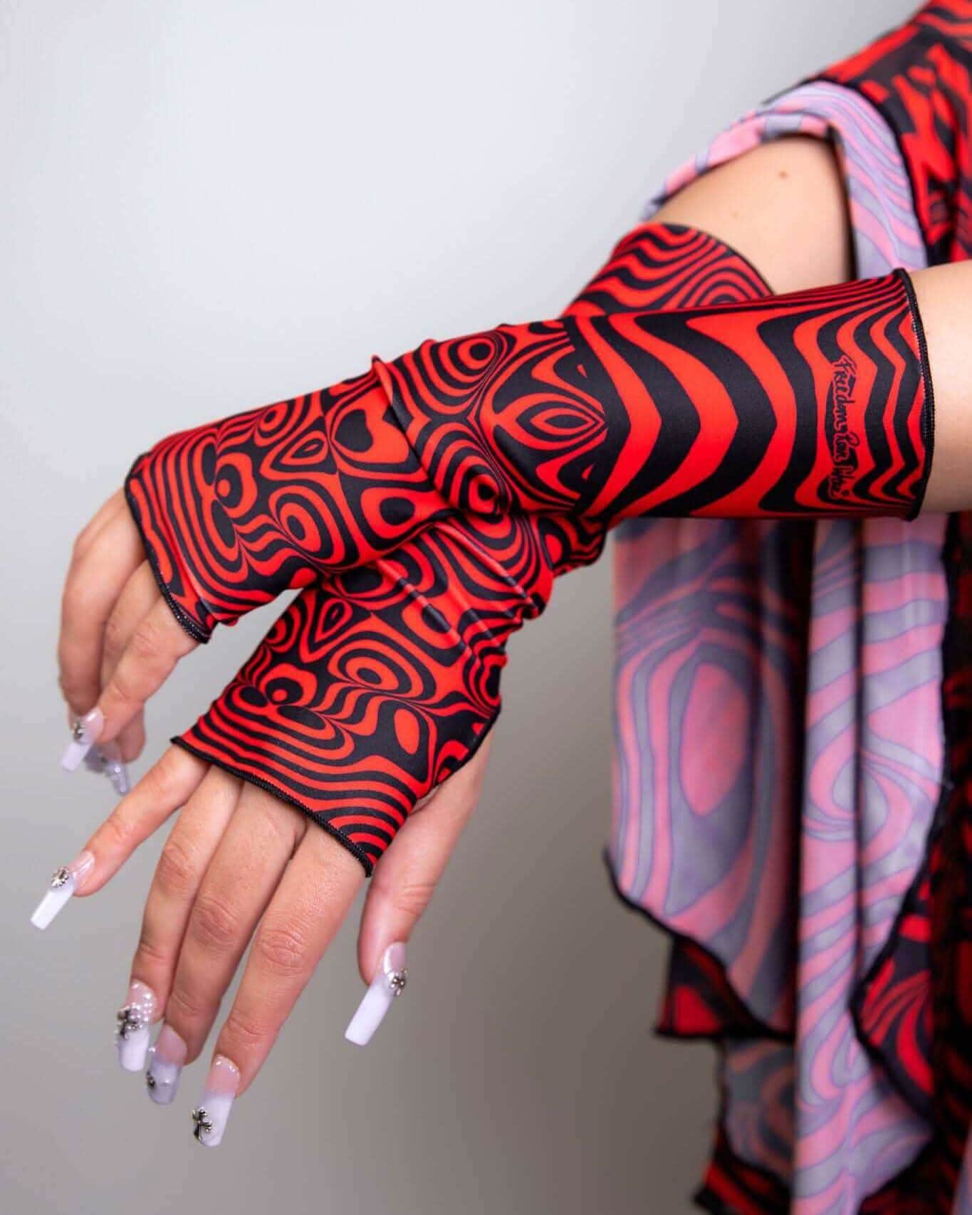 Red Void rave arm sleeves with psychedelic black swirl patterns, fingerless design for festival outfit styling