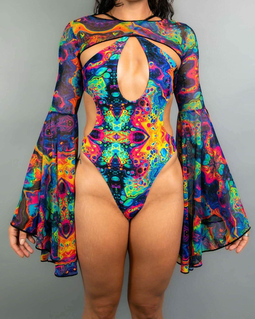 Model wearing Vivid psychedelic rave arm sleeves with dramatic bell sleeves in multicolored festival outfit front view