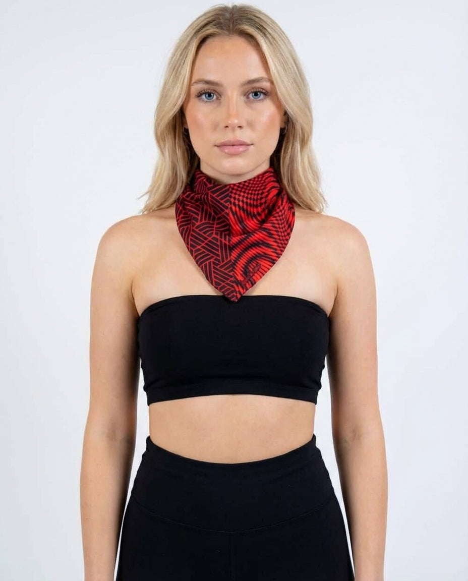 Amplitude Bandana front view, a red and black rave bandana with geometric and psychedelic patterns, worn by a woman.