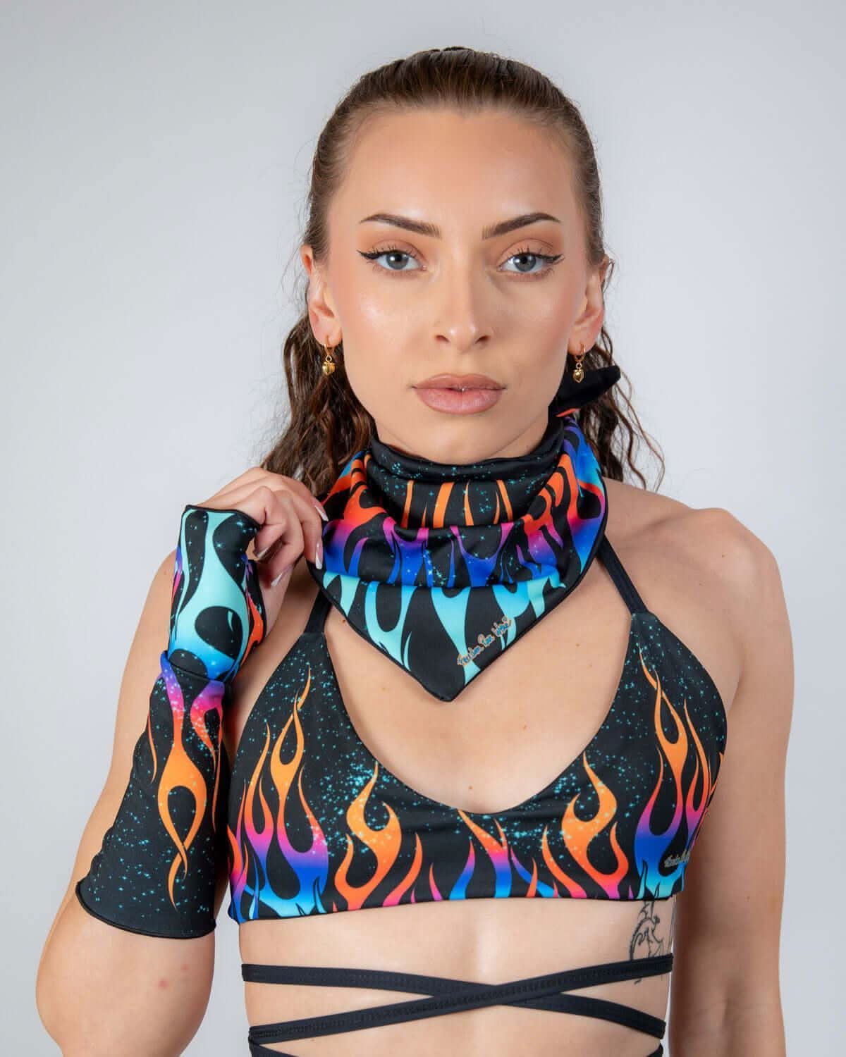 Front view of a model wearing the Blaze Bandana, featuring vibrant orange, blue, and purple flames on a black backdrop, perfect rave accessory.
