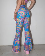 Groovy Bell Bottoms seen from the back, featuring a vibrant psychedelic rave pattern with smiley faces and rainbows.