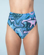 Glacial High Waisted Bikini Bottoms front view, featuring a unique blue and lilac swirl pattern, perfect for rave festivals.