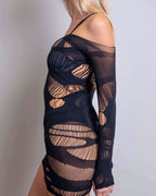 Black Dark Dimensions fishnet rave bodysuit dress with distressed mesh cutouts, side view on blonde model