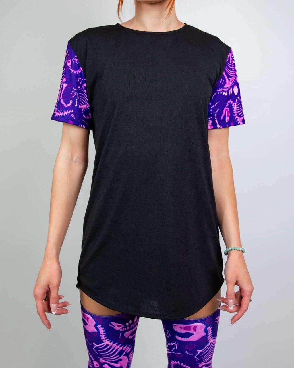 Black rave bodysuit style t-shirt with purple dinosaur fossil sleeves - Baby Steps festival outfit front view