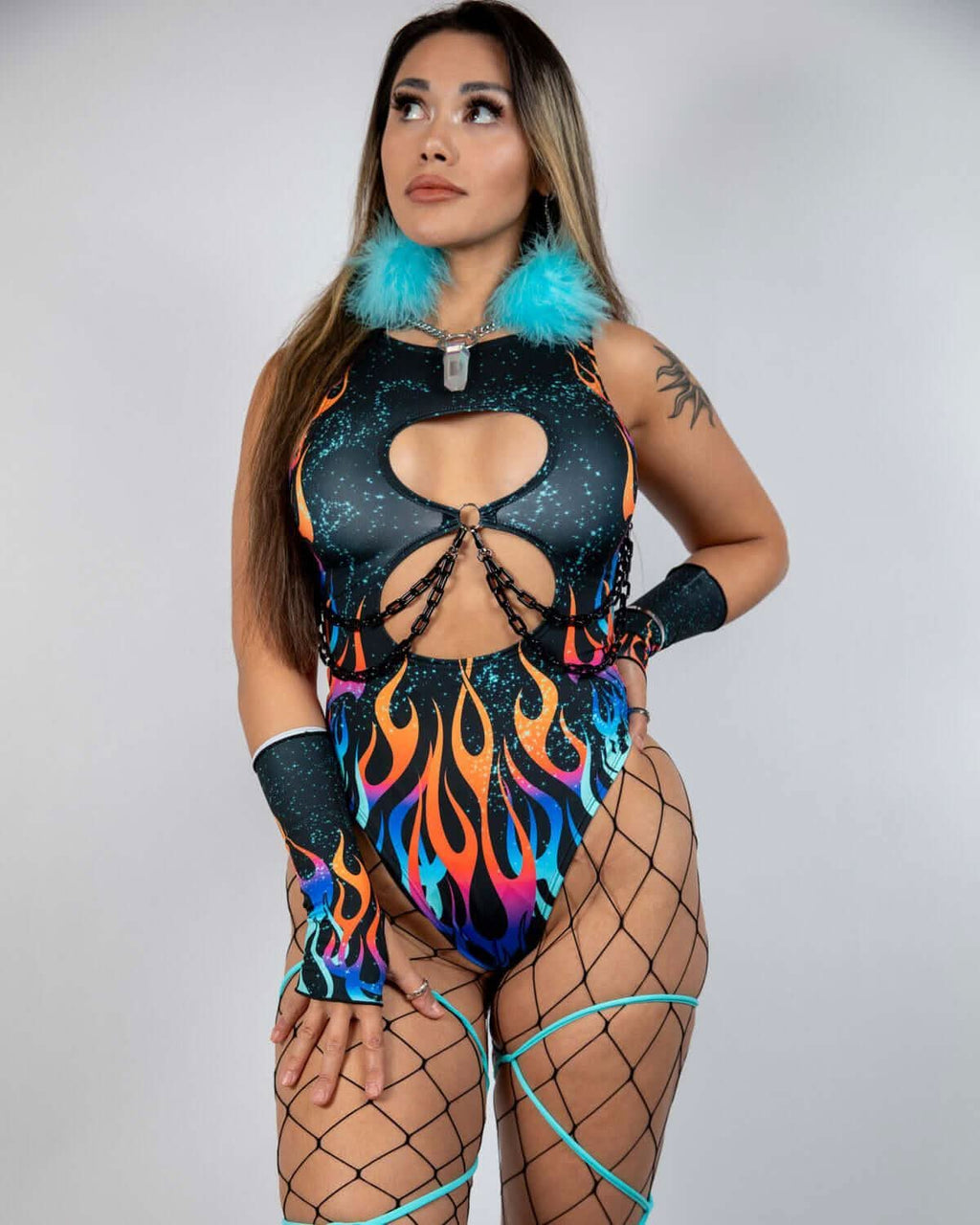 Side view of model in Blaze rave bodysuit with keyhole cutouts, flame print and turquoise fur collar