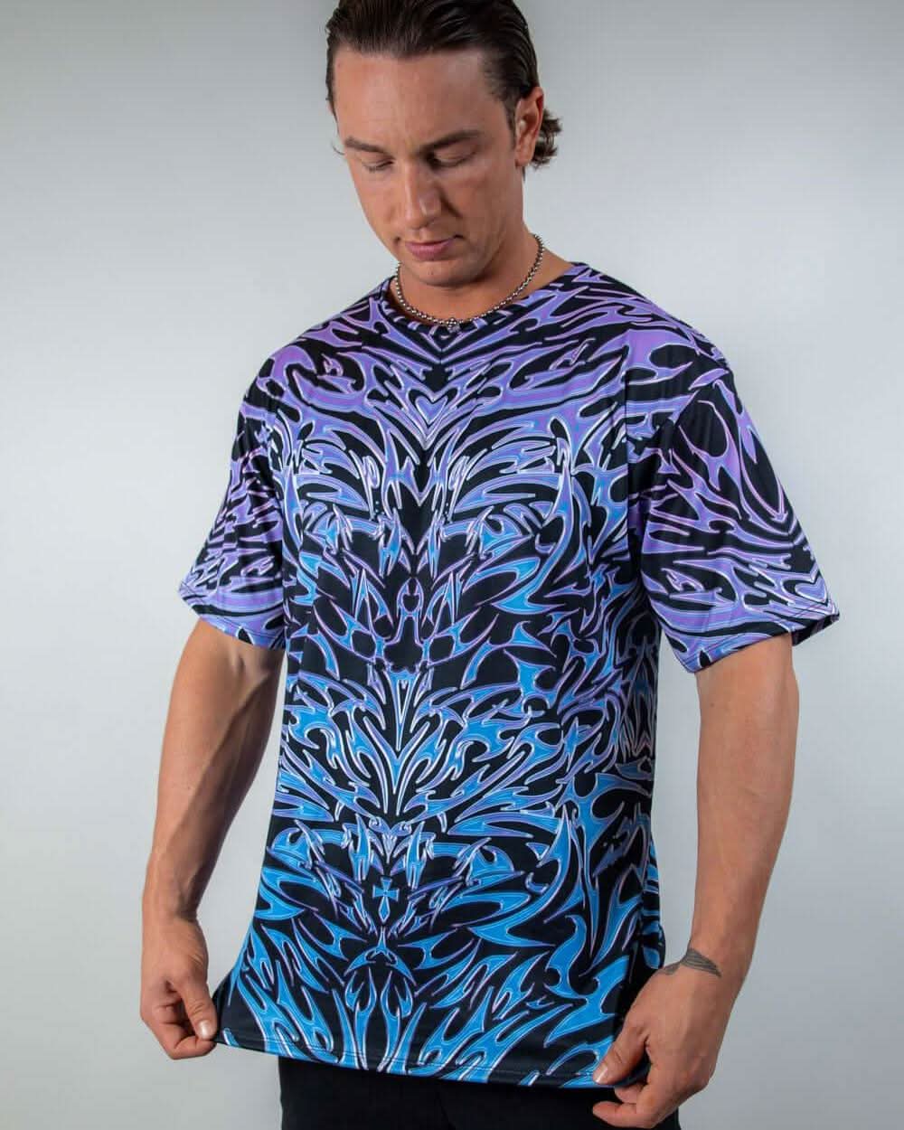 Male model in Chromium oversized rave bodysuit style tee with purple blue gradient tribal print front view