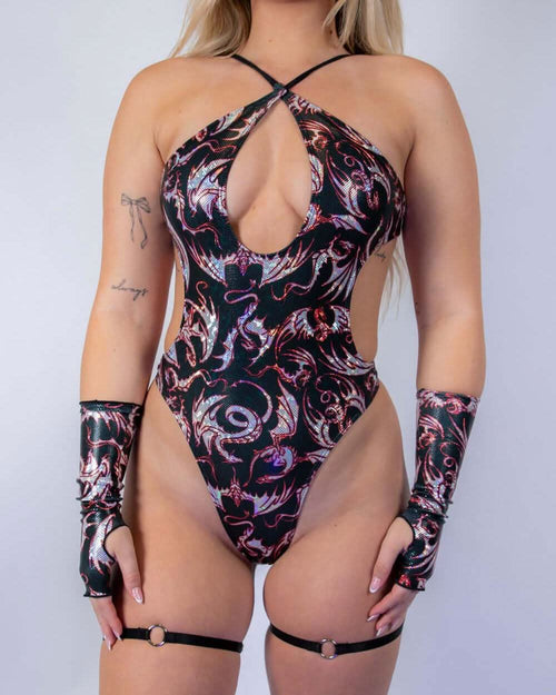 Blonde model wearing Drakonis Halo rave bodysuit with keyhole cutout and matching arm sleeves in dragon print