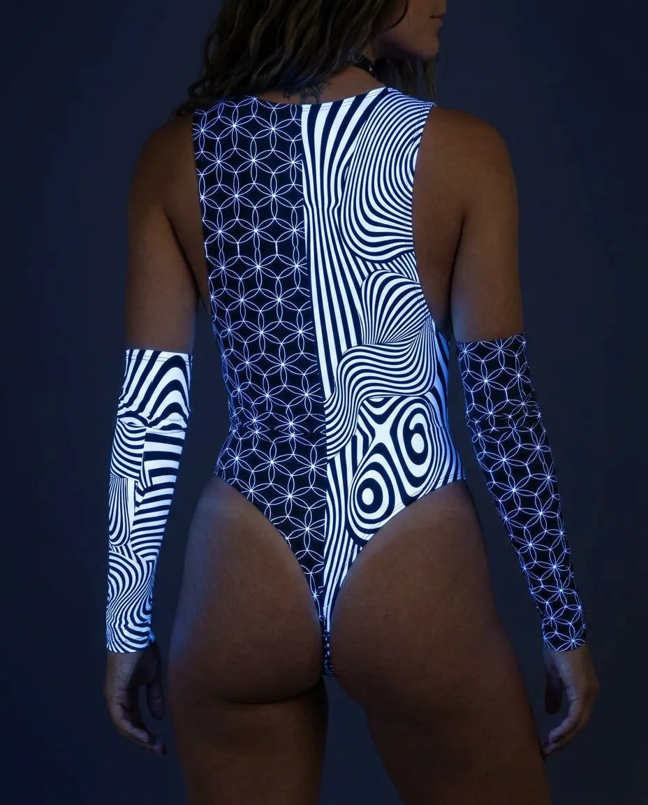 Back view of a curvy model wearing the Duality Sideboob rave bodysuit, showcasing its unique glowing blacklight patterns and matching arm sleeves.
