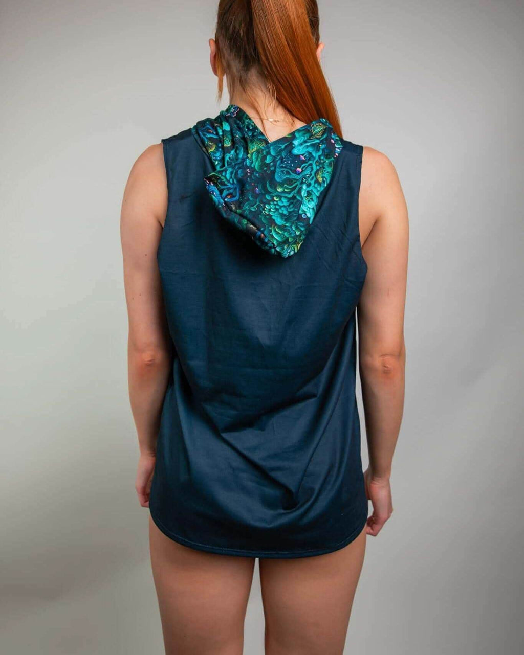 Rave bodysuit Faewood tank top back view showing navy blue fabric with teal patterned hood festival wear