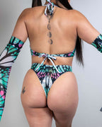 Back view of Flutter rave bodysuit with holographic butterfly print in teal and pink colors