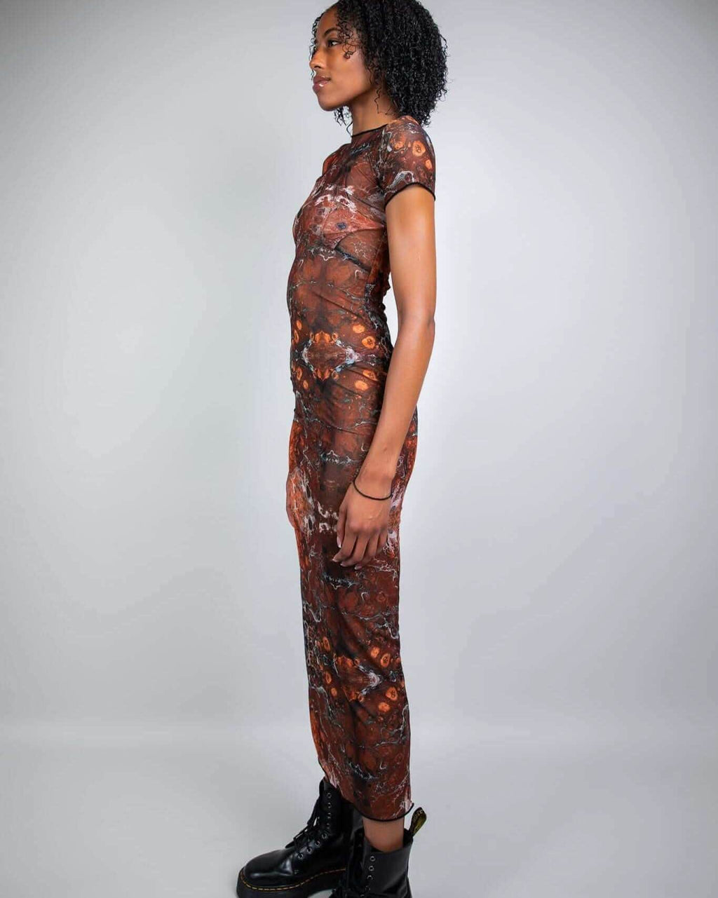 Brown fossil print mesh maxi dress rave bodysuit styled with black boots, side view festival outfit