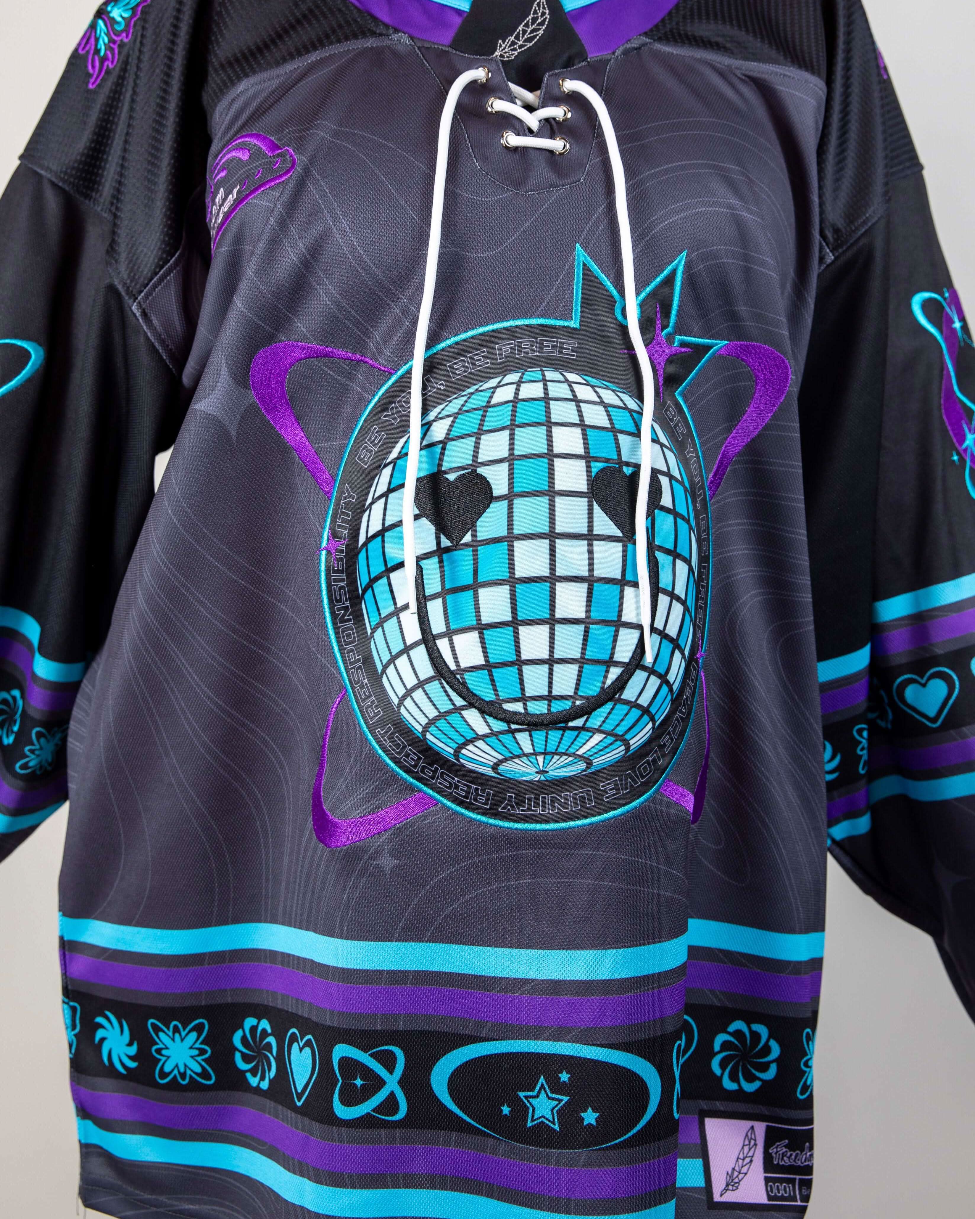 Rave bodysuit style Freedom Fam hockey jersey detail showing disco ball graphic with festival colors purple teal