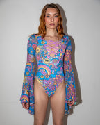 Groovy Goddess Bodysuit front view, featuring psychedelic smiley faces, peace signs, and suns in vibrant multi-color, perfect for rave festivals.