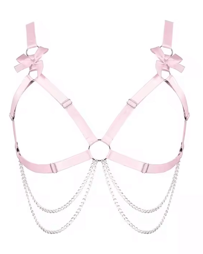 Light pink Heartthrob rave bodysuit harness with bow details and silver chains for festival outfits