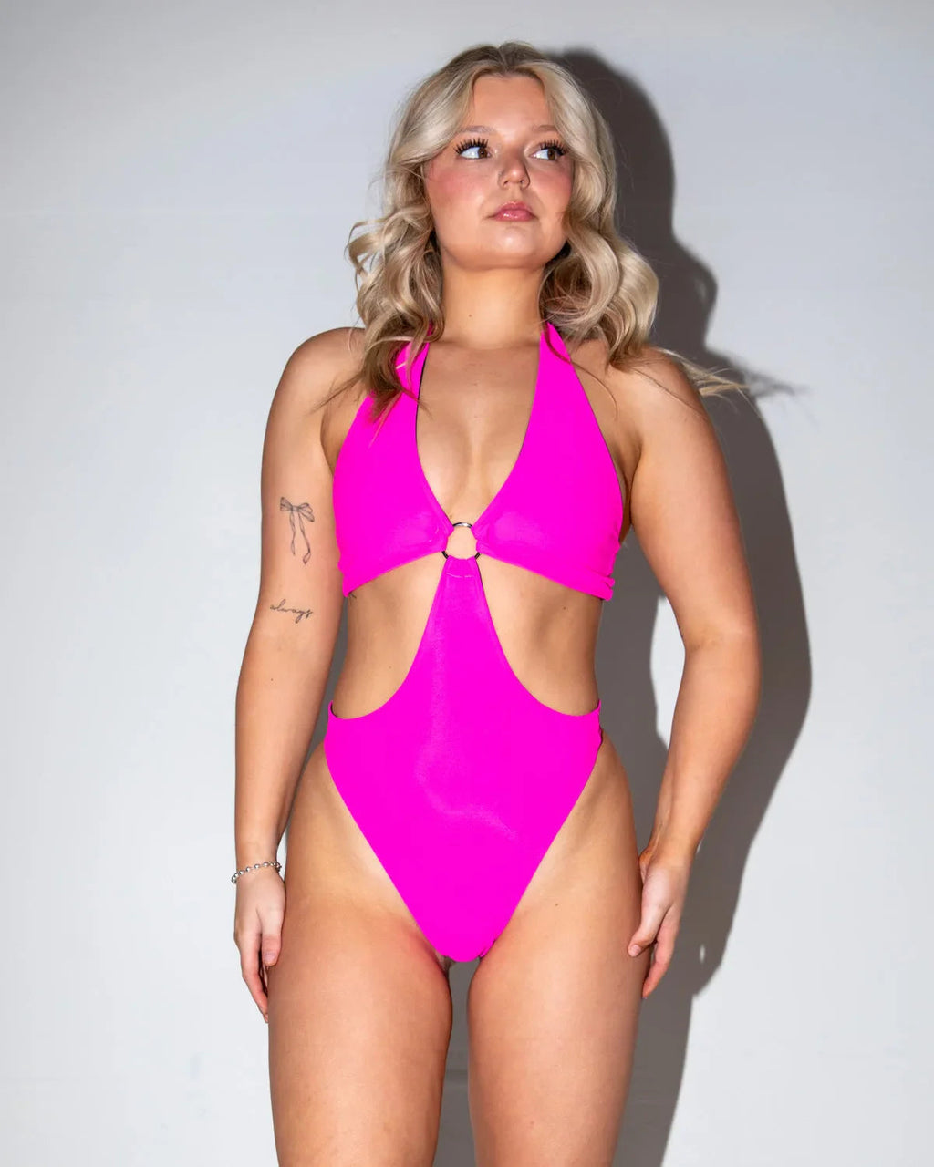 Hot Pink O-Ring Bodysuit front view on a blonde model, perfect for a rave or festival outfit.