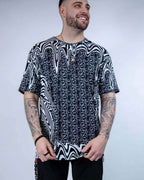 Rave bodysuit style Meltdown oversized tee with trippy black white pattern on tattooed festival model front view