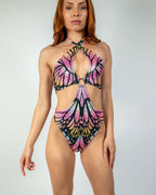 Pink butterfly rave bodysuit with cutout design modeled from front showing Monarch pattern details