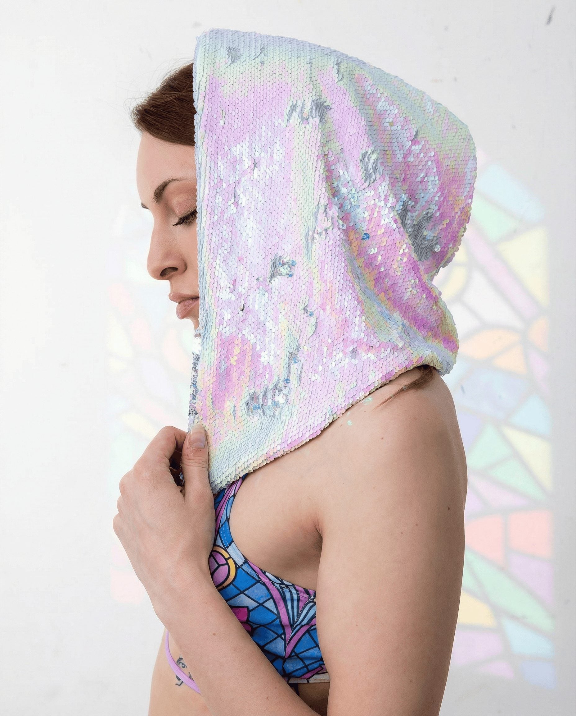 Model wearing Moonlight sequin rave hood in side profile, iridescent festival gear with holographic shimmer effects