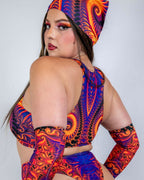 Woman wearing rave bodysuit set with Radiance bandana head wrap in purple orange fractal print back view
