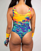 Back view of Saurian reversible rave bodysuit with tropical dinosaur print in vibrant yellows and blues