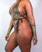 Back view of Starfire rave bodysuit in holographic gold with side tie details and matching gloves
