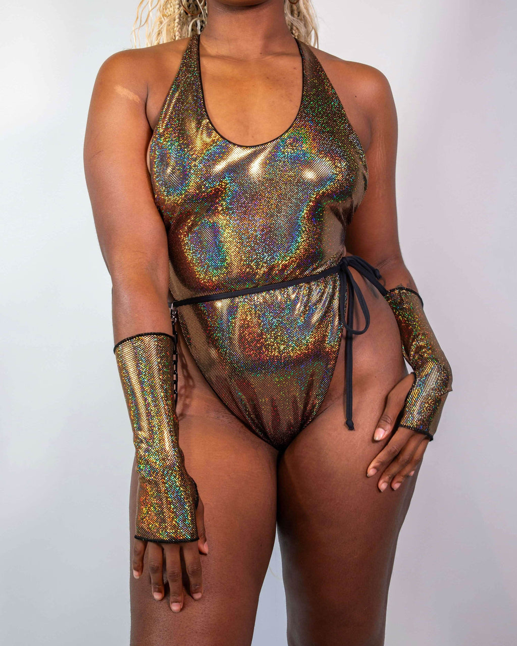 Starfire Temptation Cheeky One Piece in holographic gold, worn by a model facing front, perfect for a rave festival.