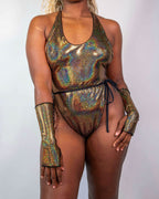 Starfire Temptation Cheeky One Piece in holographic gold, worn by a model facing front, perfect for a rave festival.