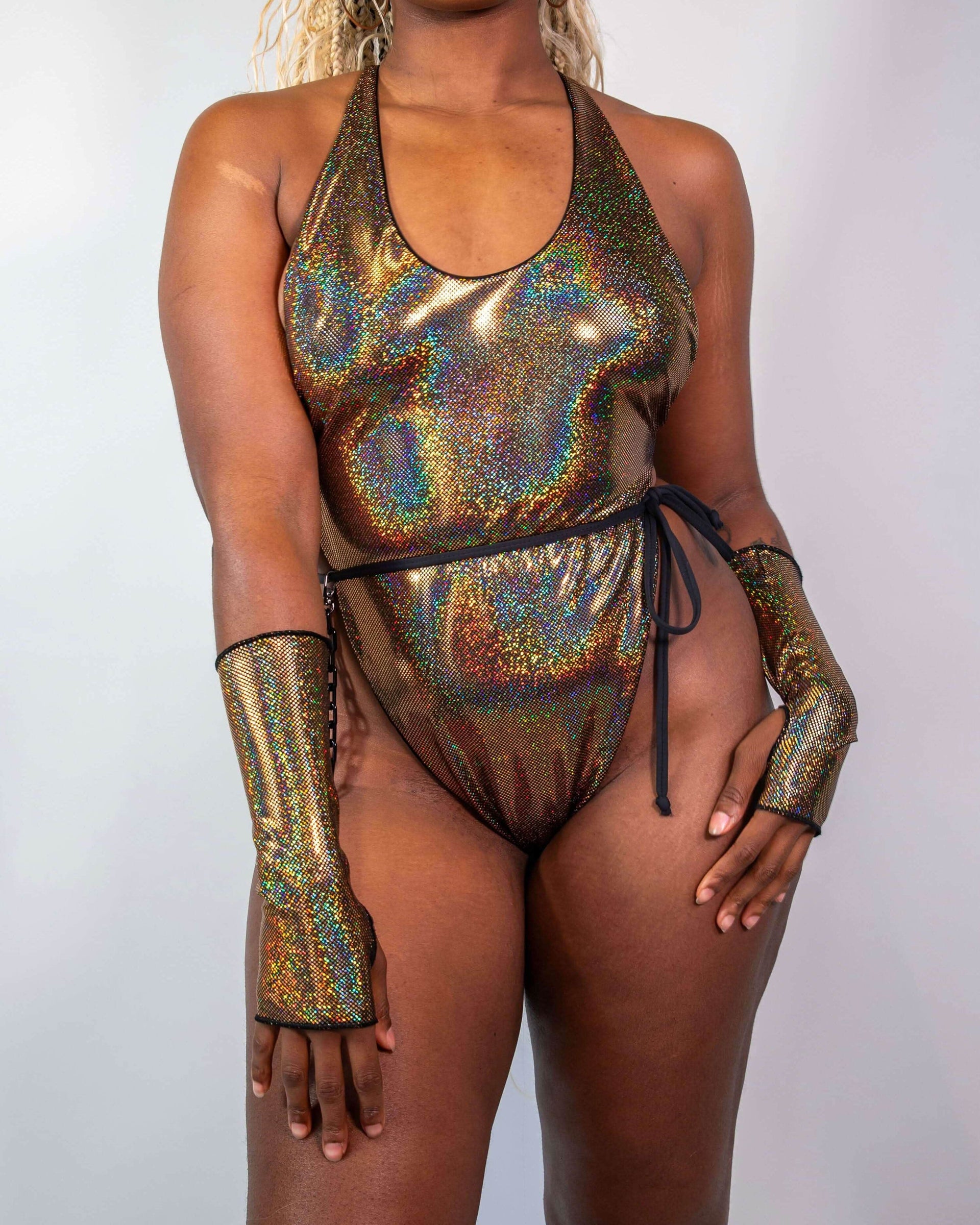 Starfire Temptation Cheeky One Piece in holographic gold, worn by a model facing front, perfect for a rave festival.