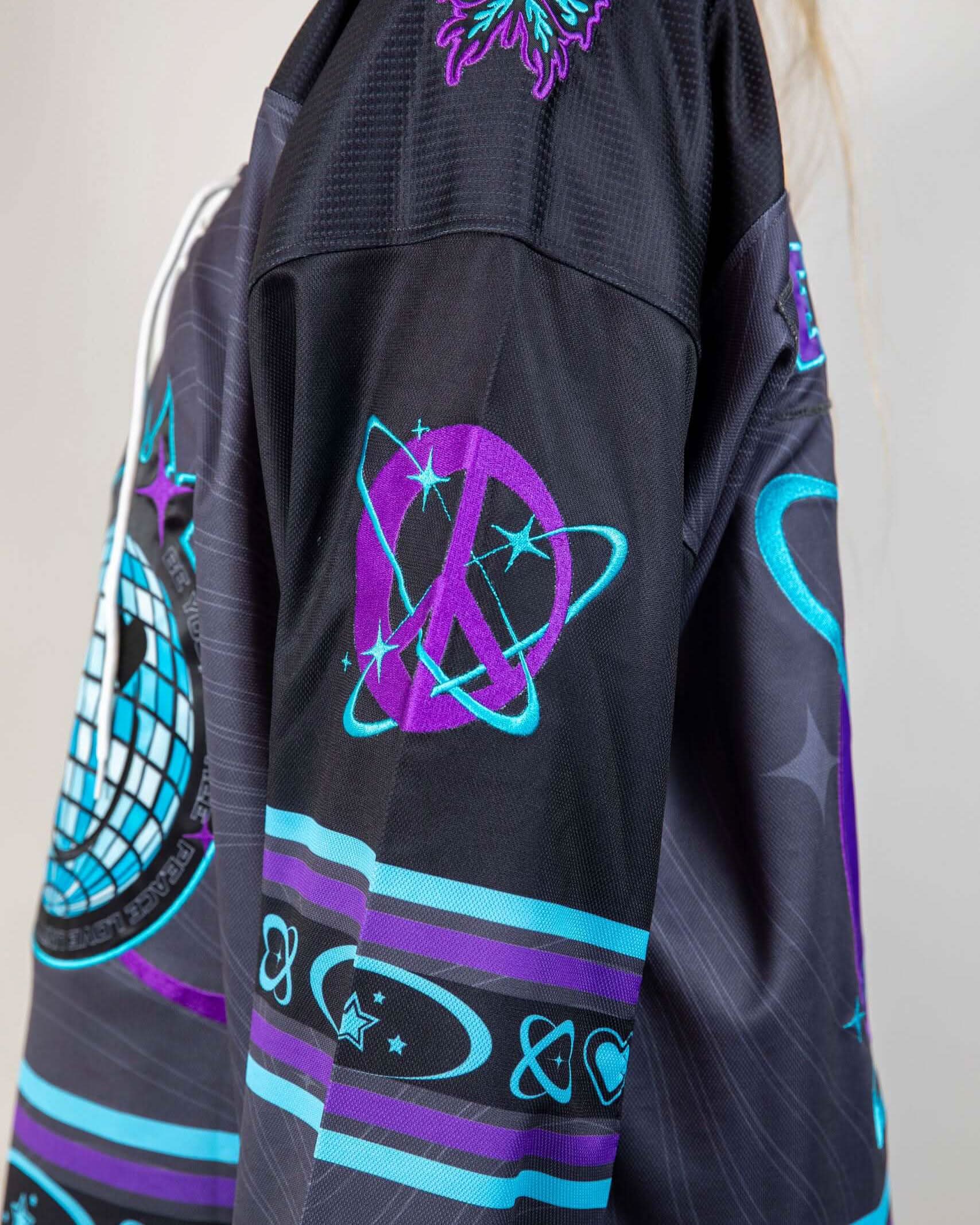 Rave bodysuit inspired Freedom Fam Hockey Jersey sleeve detail showing purple atomic graphics and festival rave wear styling