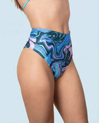 Side view of Glacial High Waisted Bikini Bottoms, featuring a unique swirling pattern of blue, teal, and lilac, perfect for rave festivals.