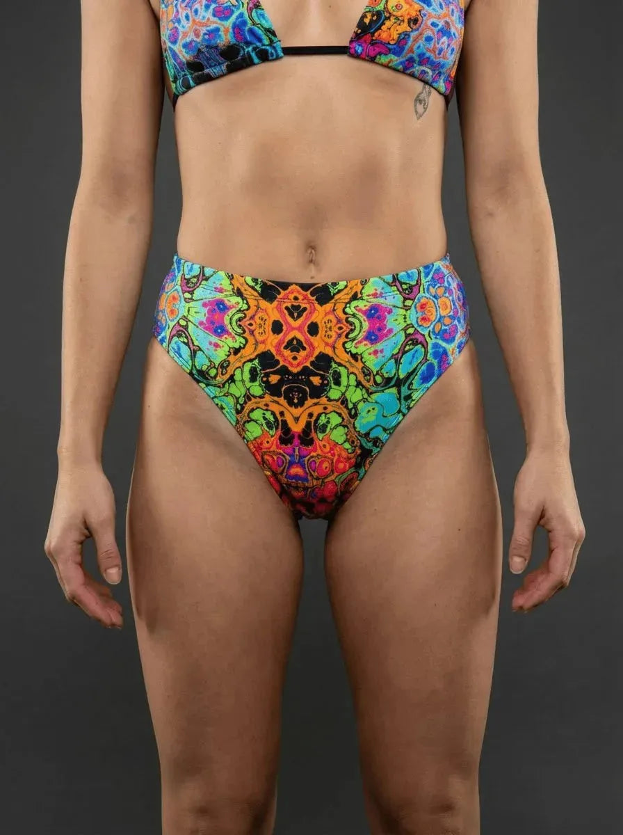 Lucidity High Waisted Brazilian Bottoms front view, featuring a vibrant psychedelic rave pattern in green, orange, blue, and pink.