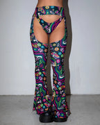 Awaken Bell Chaps front view, featuring a vibrant psychedelic pattern with mushrooms and eyes, perfect for rave festivals.