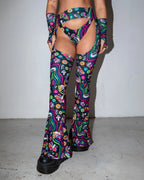 Awaken Bell Chaps front view, featuring a vibrant psychedelic pattern with eyes and mushrooms, perfect for rave festivals.