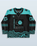 DnB Hockey Jersey rave bodysuit in turquoise and black with grid patterns and wave designs, front view