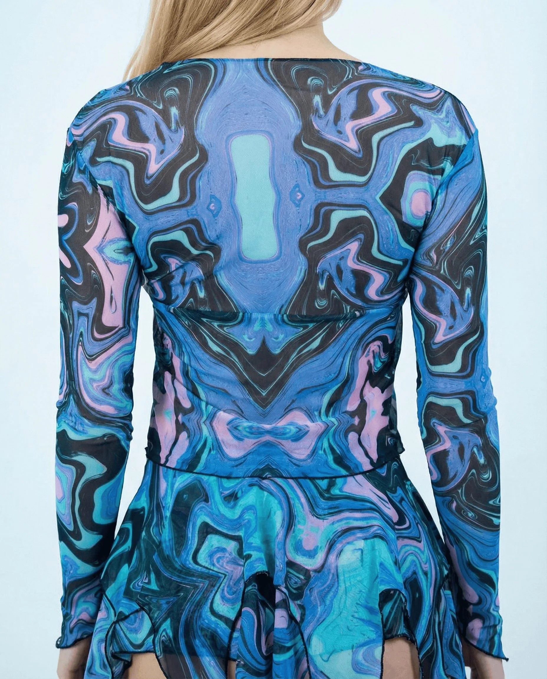 Back view of Glacial Sea Fairy rave top with swirling blue teal purple marbled design on model